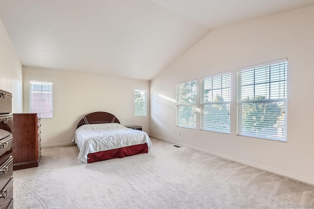 bedroom with light carpet and vaulted ceiling