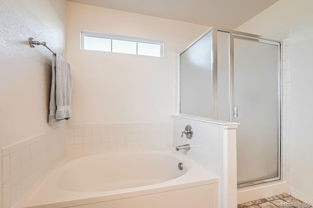 bathroom featuring separate shower and tub