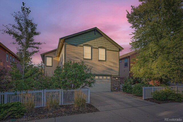 5892 W 94th Pl, Westminster, CO 80031 - view of front facade featuring an attached garage, concrete driveway, and fence