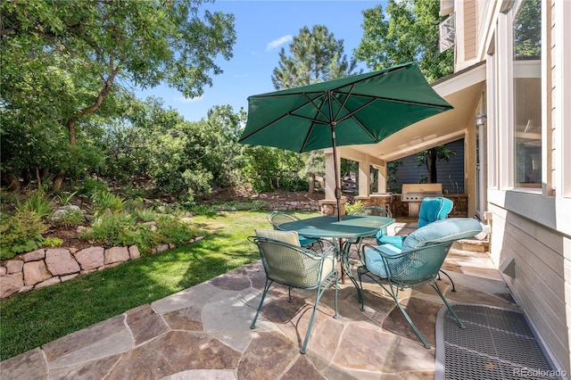 view of patio with outdoor dining area and a grill