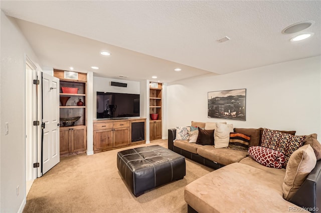 living area featuring recessed lighting, light colored carpet, a textured ceiling, and baseboards