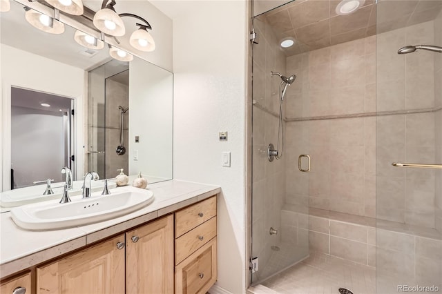 bathroom featuring a shower stall and vanity