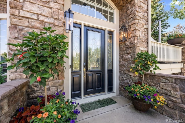 doorway to property with stone siding