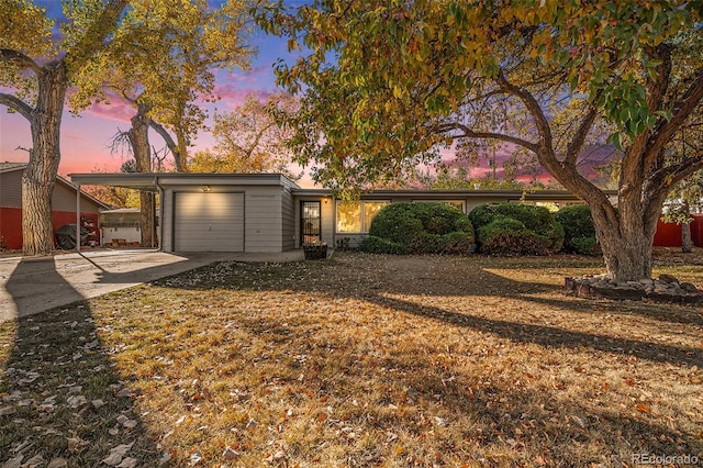 ranch-style home with a lawn and a garage