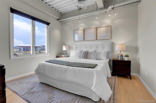 bedroom with hardwood / wood-style floors