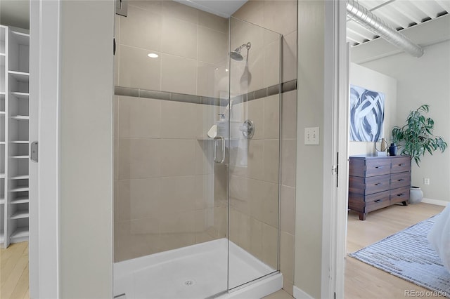 bathroom featuring an enclosed shower and hardwood / wood-style floors