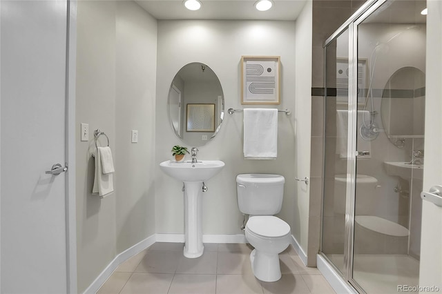 bathroom with an enclosed shower, tile patterned flooring, and toilet