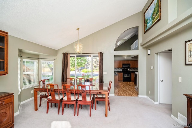 4218 E Flanders St, Denver, CO 80249 - dining space with light carpet, a chandelier, and vaulted ceiling