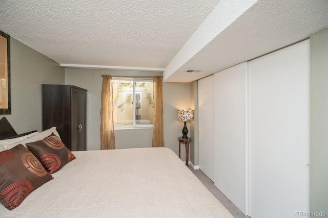4218 E Flanders St, Denver, CO 80249 - bedroom with carpet flooring and a textured ceiling