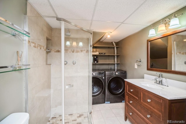 4218 E Flanders St, Denver, CO 80249 - bathroom with washer and dryer, vanity, a shower stall, tile patterned flooring, and a drop ceiling