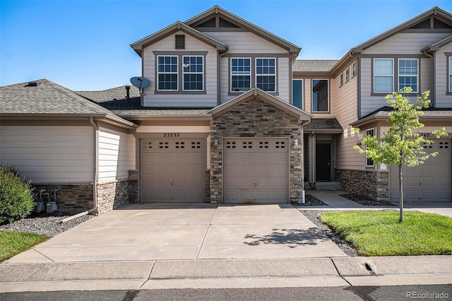 23235 York Ave, Parker, CO 80138 - view of front of property with stone siding, concrete driveway, a garage, and roof with shingles