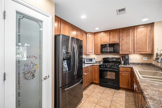 23235 York Ave, Parker, CO 80138 - kitchen with black appliances, light tile patterned floors, brown cabinetry, recessed lighting, and dark countertops