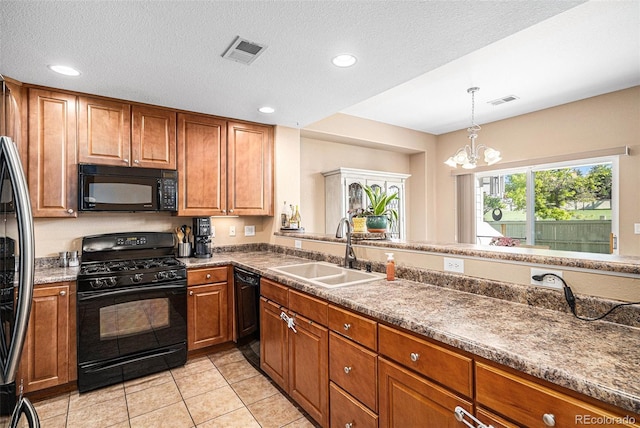 23235 York Ave, Parker, CO 80138 - kitchen featuring black appliances, brown cabinetry, a chandelier, recessed lighting, and pendant lighting