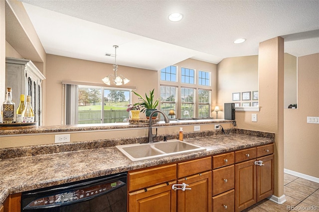 23235 York Ave, Parker, CO 80138 - kitchen featuring black dishwasher, brown cabinetry, dark countertops, plenty of natural light, and a textured ceiling