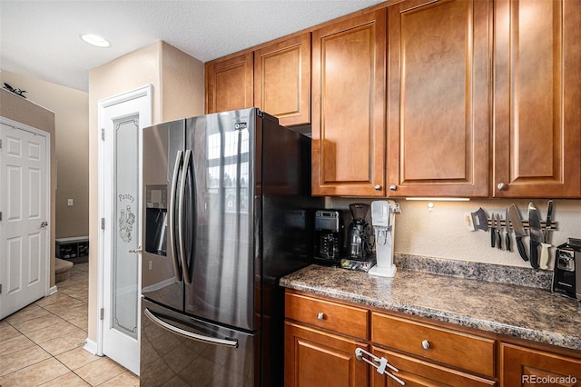 23235 York Ave, Parker, CO 80138 - kitchen with stainless steel fridge with ice dispenser, brown cabinetry, and light tile patterned flooring