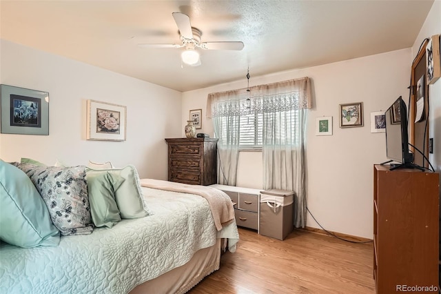 10223 W 77th Dr, Arvada, CO 80005 - bedroom with light wood-style floors and ceiling fan