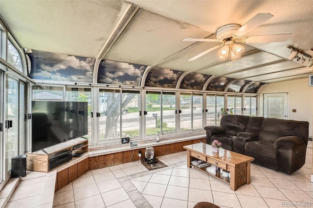 10223 W 77th Dr, Arvada, CO 80005 - sunroom / solarium with tile patterned flooring, plenty of natural light, lofted ceiling, and a textured ceiling