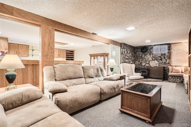 10223 W 77th Dr, Arvada, CO 80005 - carpeted living area with a wood stove, a textured ceiling, and wooden walls