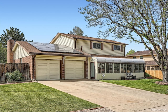 10223 W 77th Dr, Arvada, CO 80005 - traditional home featuring a sunroom, a garage, brick siding, roof mounted solar panels, and driveway