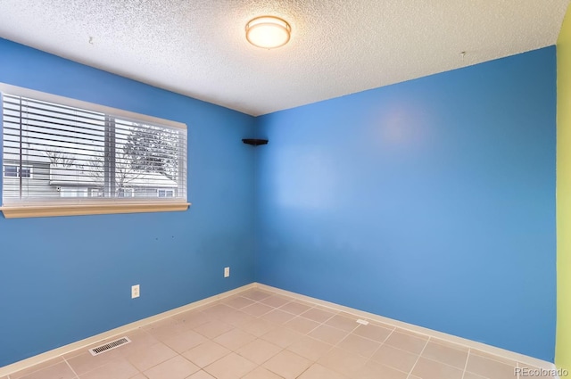 unfurnished room with a textured ceiling