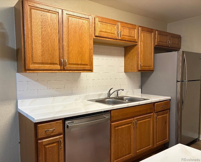 16359 W 10th Ave Unit Yy2, Golden, CO 80401 - kitchen with stainless steel appliances, light countertops, tasteful backsplash, and brown cabinets