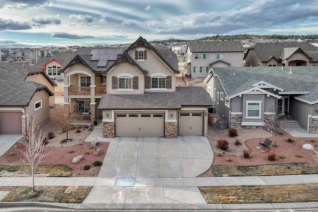 6132 Cubbage Dr, Colorado Springs, CO 80924 - view of front of home with driveway, stone siding, stucco siding, a residential view, and roof mounted solar panels