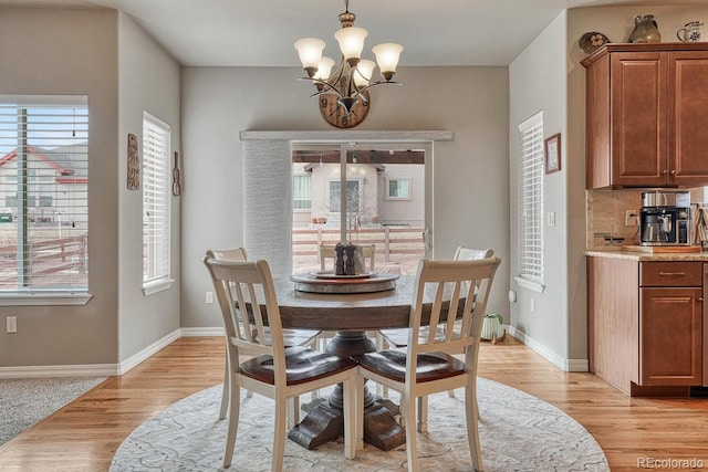6132 Cubbage Dr, Colorado Springs, CO 80924 - dining space featuring a notable chandelier, baseboards, and light wood finished floors