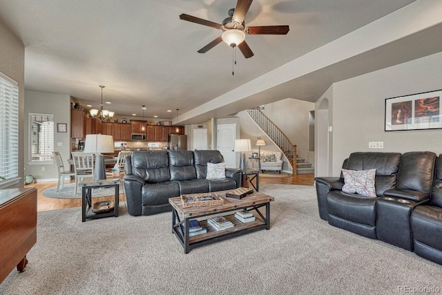 6132 Cubbage Dr, Colorado Springs, CO 80924 - living area with stairway, light wood-type flooring, ceiling fan with notable chandelier, baseboards, and a textured ceiling