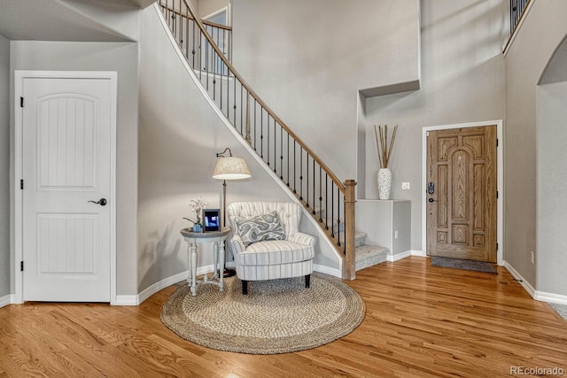 6132 Cubbage Dr, Colorado Springs, CO 80924 - entryway featuring a towering ceiling, baseboards, stairway, and wood finished floors