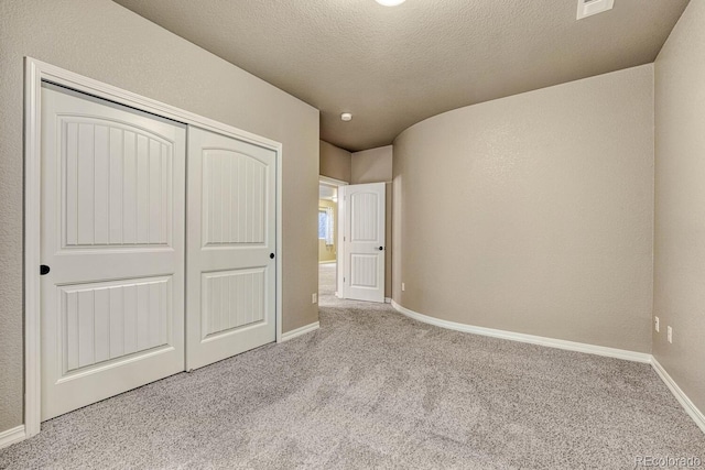 6132 Cubbage Dr, Colorado Springs, CO 80924 - unfurnished bedroom with carpet flooring, a textured wall, baseboards, a textured ceiling, and a closet