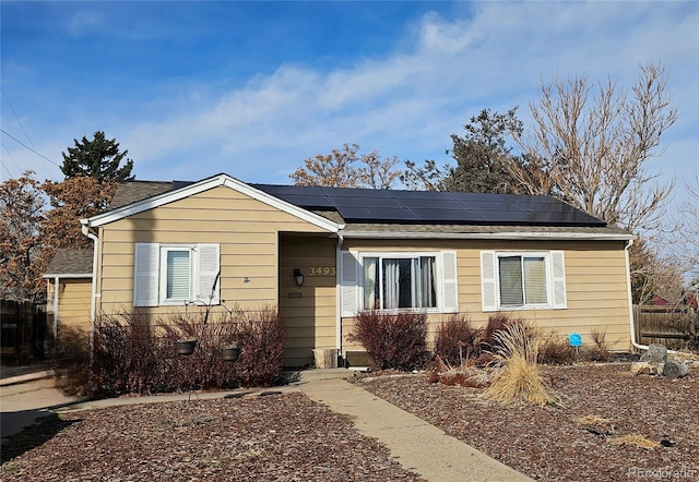 view of front facade with roof mounted solar panels