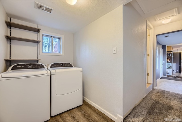 clothes washing area featuring visible vents, dark wood-type flooring, separate washer and dryer, baseboards, and attic access