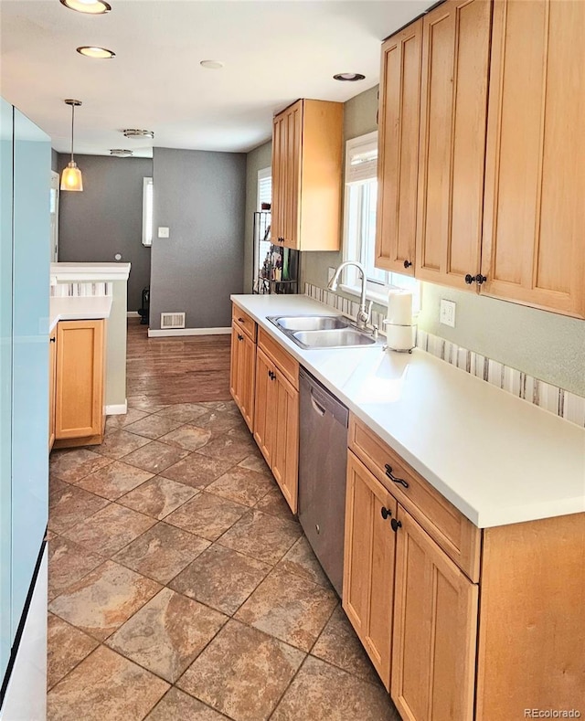 3493 S Eudora St, Denver, CO 80222 - kitchen with stainless steel dishwasher, a sink, stone tile flooring, baseboards, and hanging light fixtures