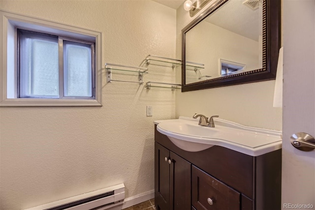3493 S Eudora St, Denver, CO 80222 - bathroom with baseboard heating, vanity, and a textured wall