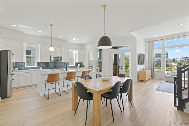16722 Shoshone St, Broomfield, CO 80023 - dining area featuring light wood-style flooring, recessed lighting, and french doors