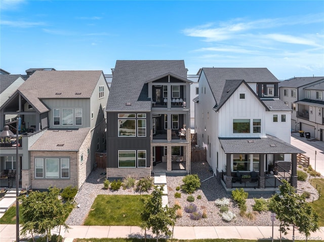 16722 Shoshone St, Broomfield, CO 80023 - rear view of house featuring board and batten siding, a balcony, a residential view, and a shingled roof