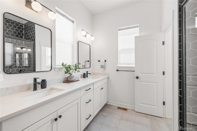 16722 Shoshone St, Broomfield, CO 80023 - bathroom with plenty of natural light, double vanity, tile patterned flooring, and baseboards