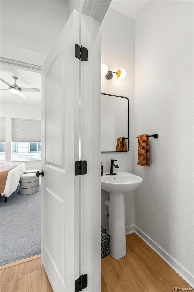 16722 Shoshone St, Broomfield, CO 80023 - bathroom with baseboards, ceiling fan, wood finished floors, ensuite bathroom, and a sink