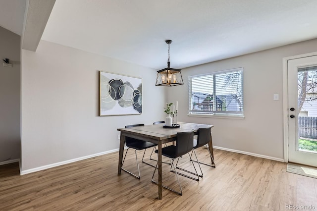 4620 E 135th Way, Thornton, CO 80241 - dining area with light wood finished floors, baseboards, and a chandelier