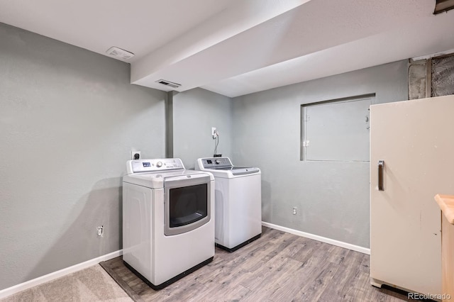 4620 E 135th Way, Thornton, CO 80241 - laundry room featuring washing machine and clothes dryer, light wood-style flooring, and baseboards