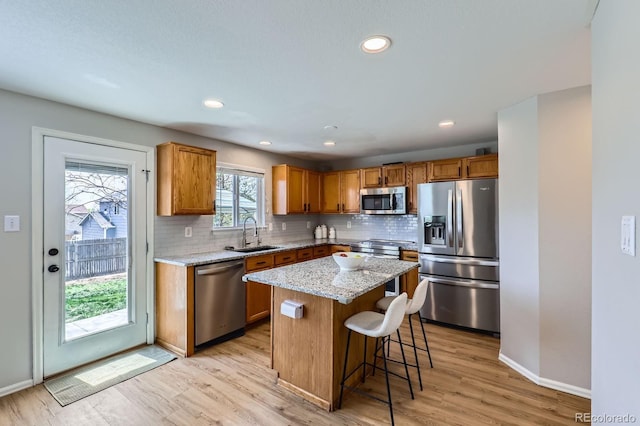 4620 E 135th Way, Thornton, CO 80241 - kitchen featuring appliances with stainless steel finishes, a sink, decorative backsplash, baseboards, and recessed lighting