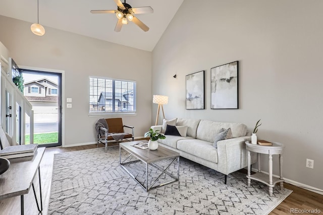 4620 E 135th Way, Thornton, CO 80241 - living room featuring high vaulted ceiling, wood finished floors, healthy amount of natural light, ceiling fan, and baseboards