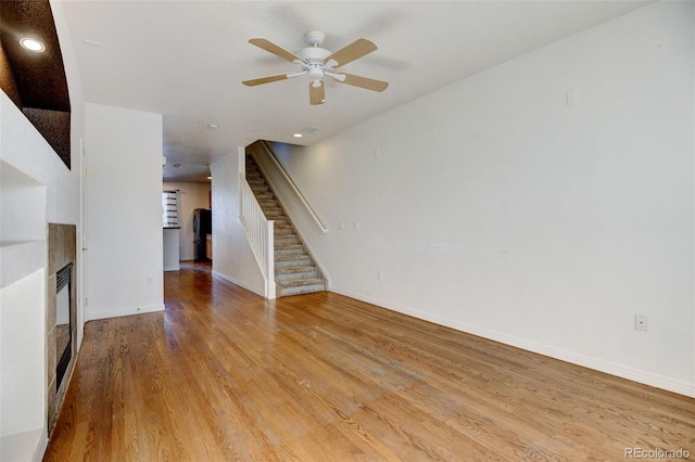 unfurnished living room with light hardwood / wood-style floors and ceiling fan