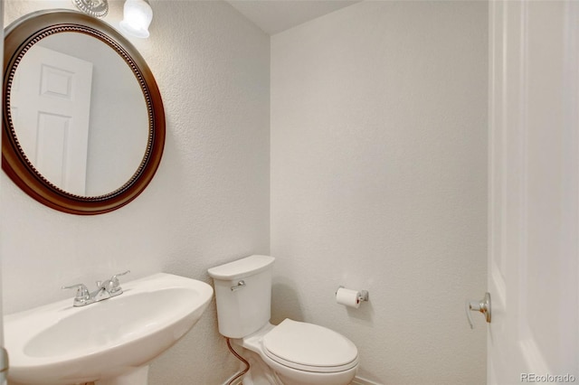 bathroom featuring sink and toilet