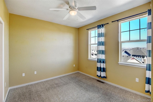 carpeted empty room featuring ceiling fan