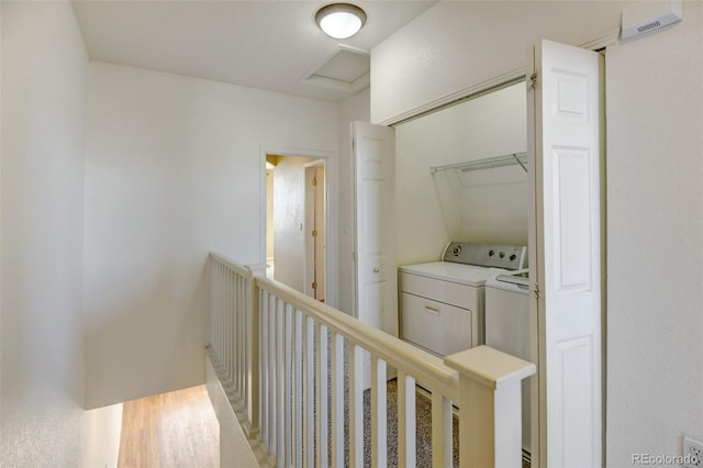 hall with wood-type flooring and washer and clothes dryer