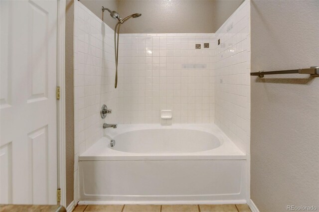 bathroom featuring washtub / shower combination and tile patterned flooring