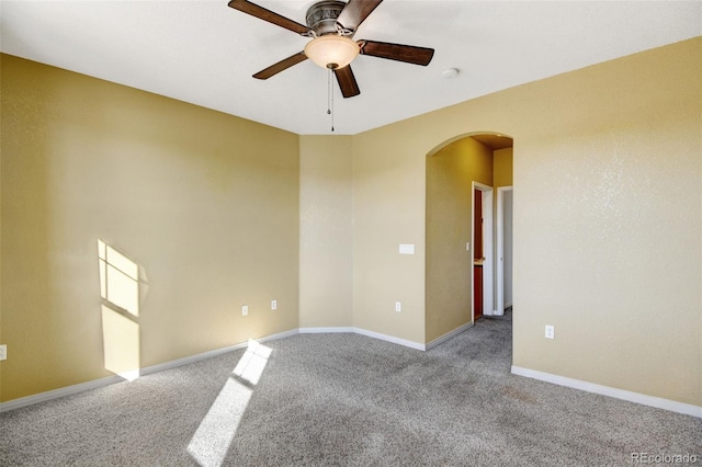 unfurnished room with light colored carpet and ceiling fan