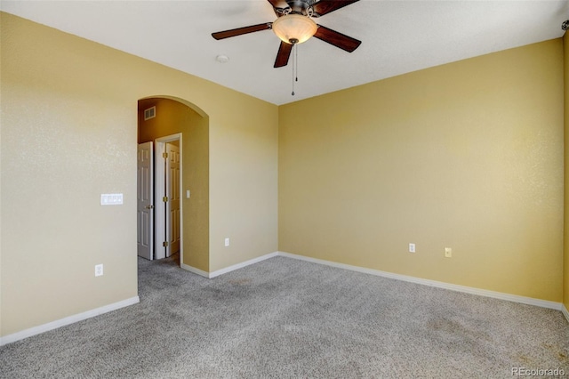 carpeted spare room featuring ceiling fan