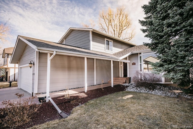 view of side of home with a lawn, concrete driveway, a garage, and roof with shingles